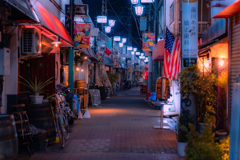 a narrow street with a lot of lights hanging above it
