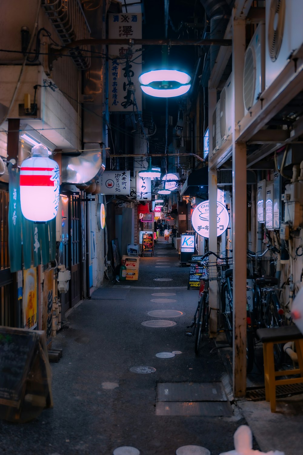 a narrow alley way with a bike parked on the side of it