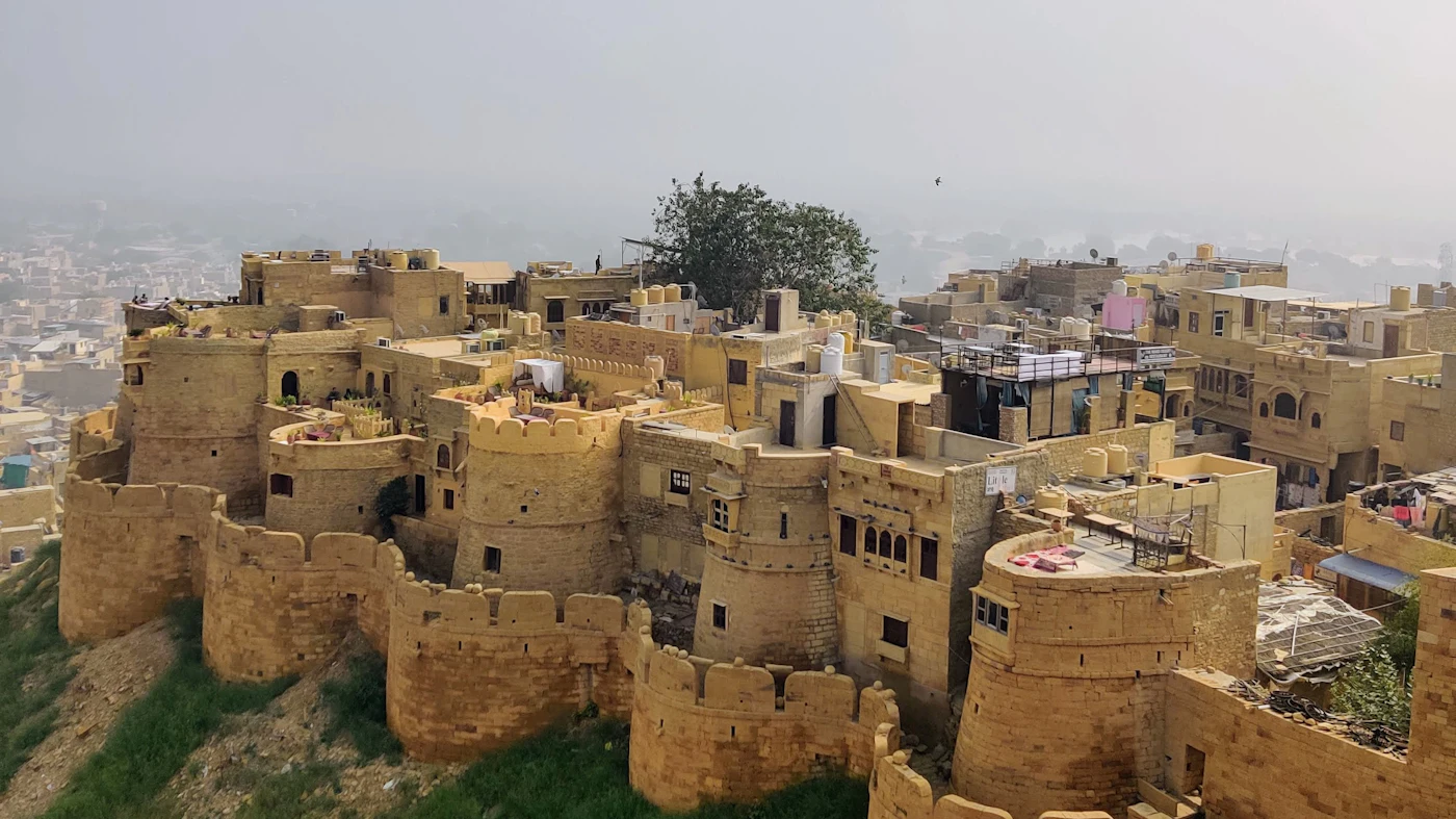 The golden sandstone ramparts of Jaisalmer Fort rising from the Thar Desert at sunrise in Rajasthan, India