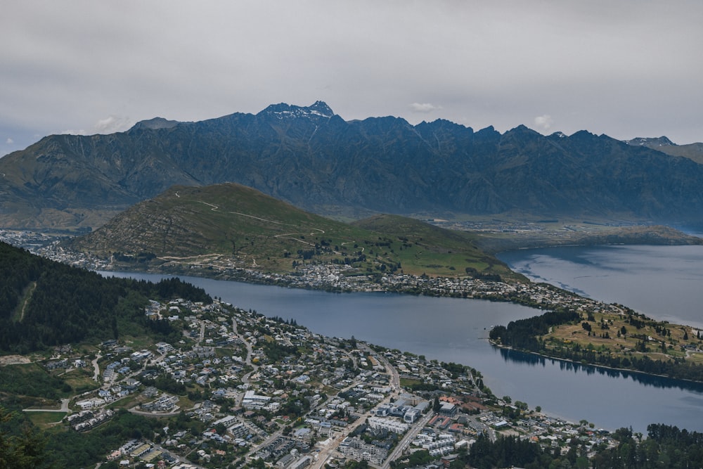 a view of a city and a lake from the top of a mountain