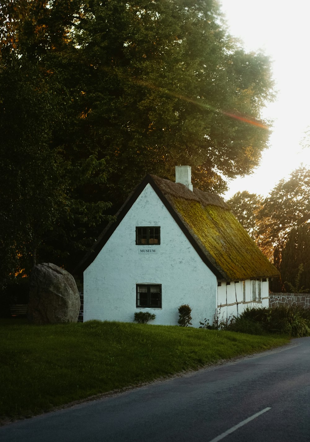 a white house sitting on the side of a road