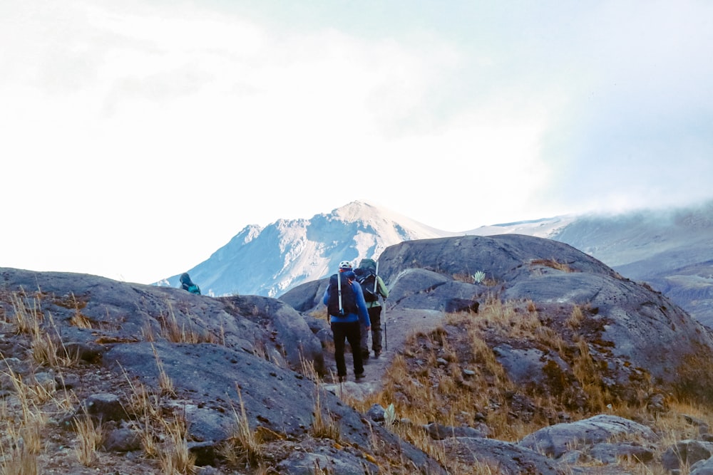 a couple of people walking up a hill