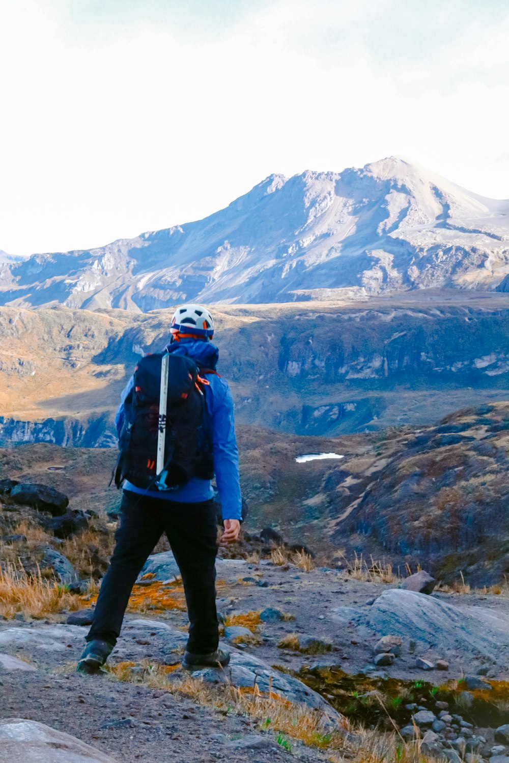 a man standing on top of a rocky hillside