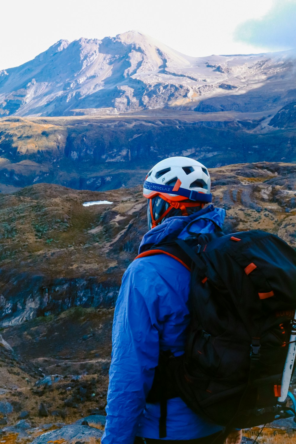 a person with a backpack and skis on a mountain