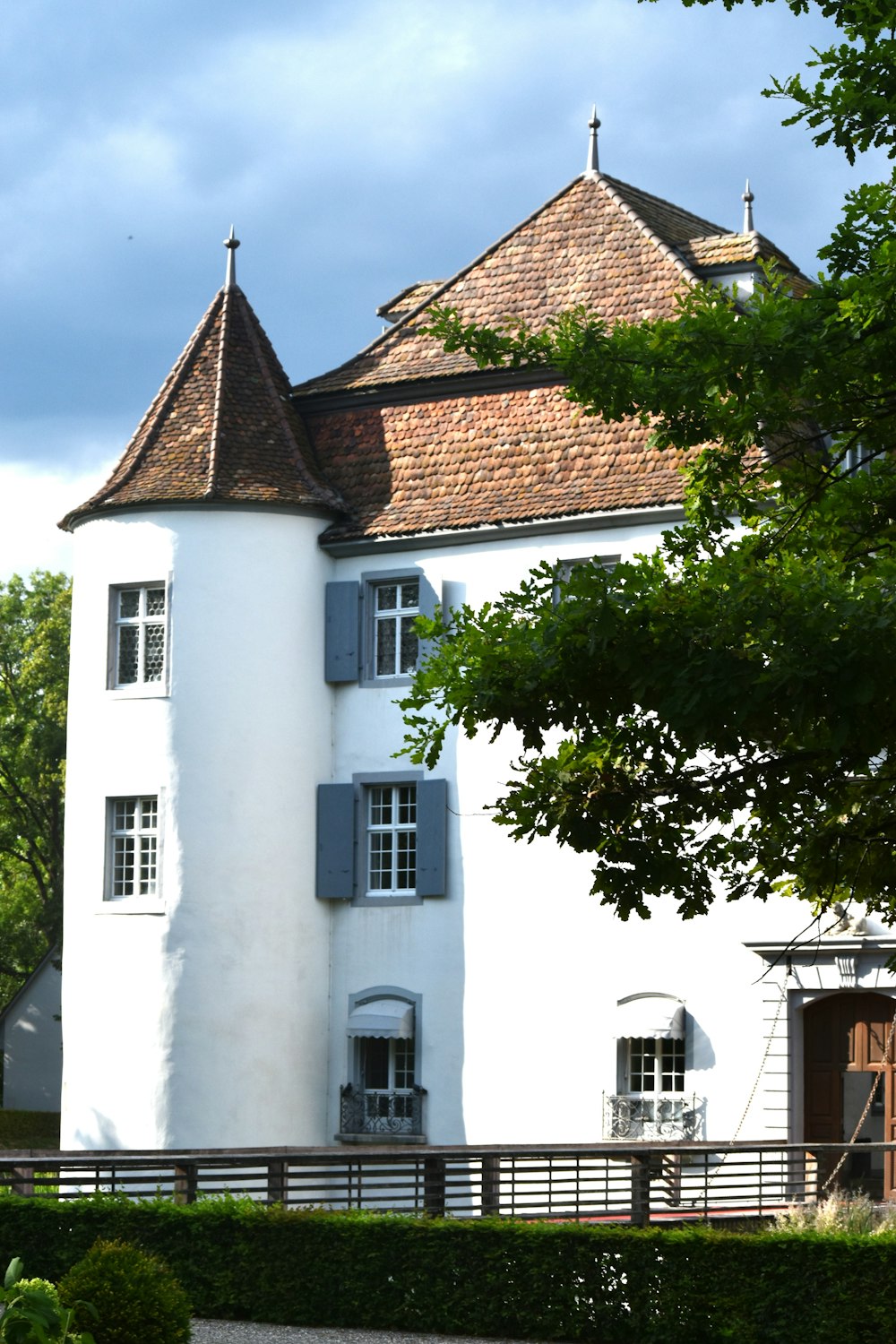 a large white building with a clock on the front of it