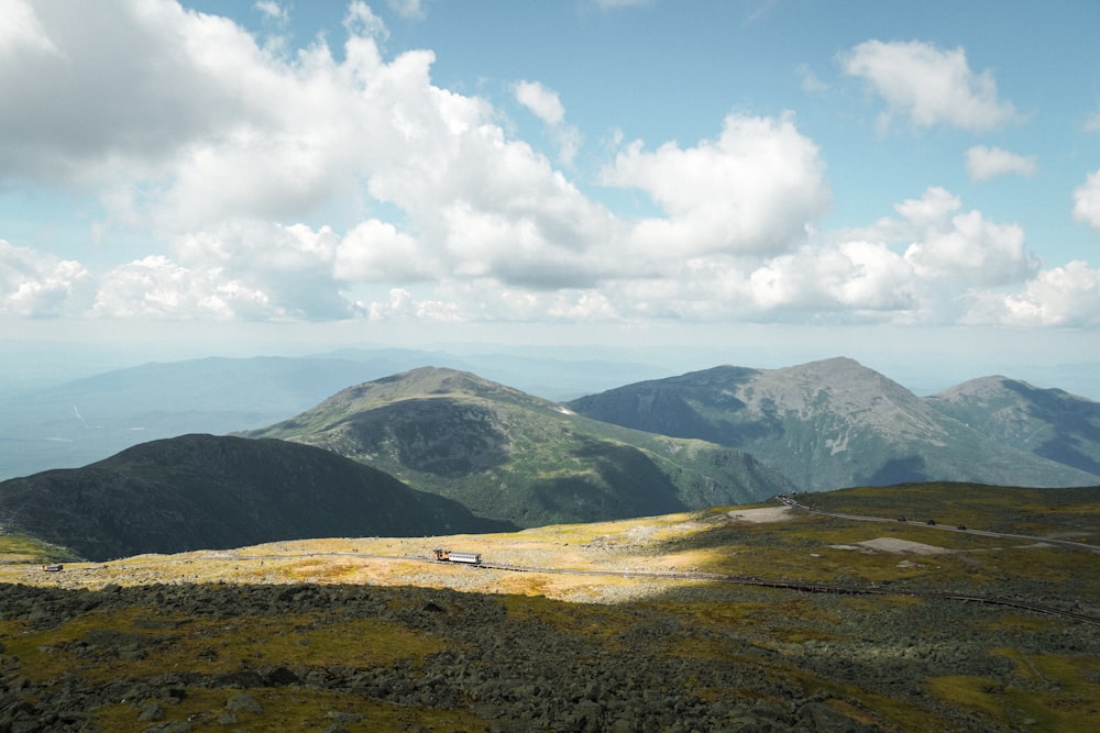 a scenic view of a mountain range with clouds in the sky