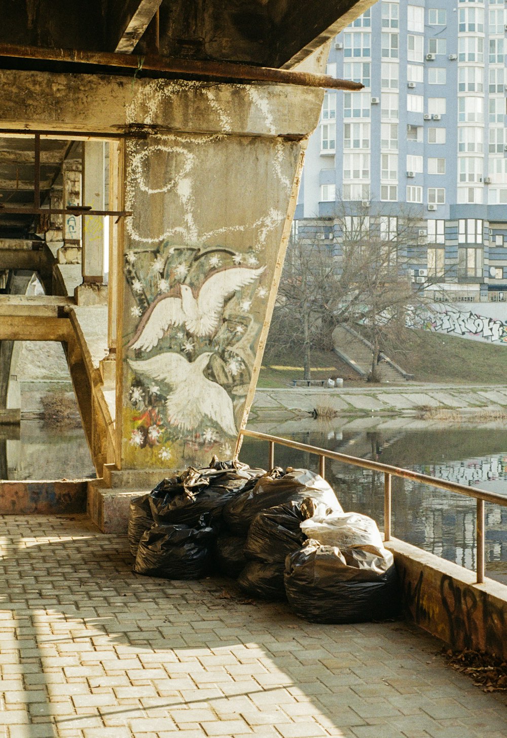 a bunch of trash bags sitting on the side of a building