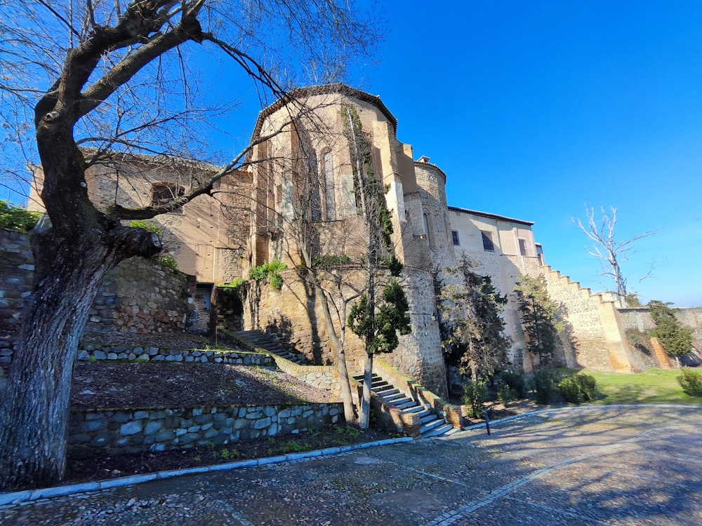 a stone building with a tree in front of it