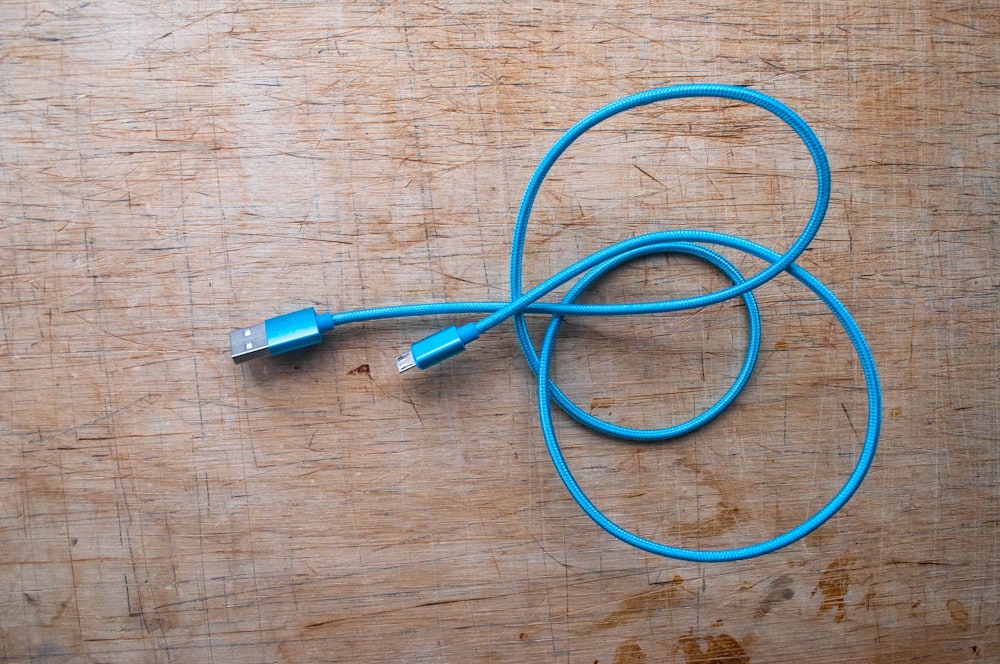 a close up of a cord on a wooden surface