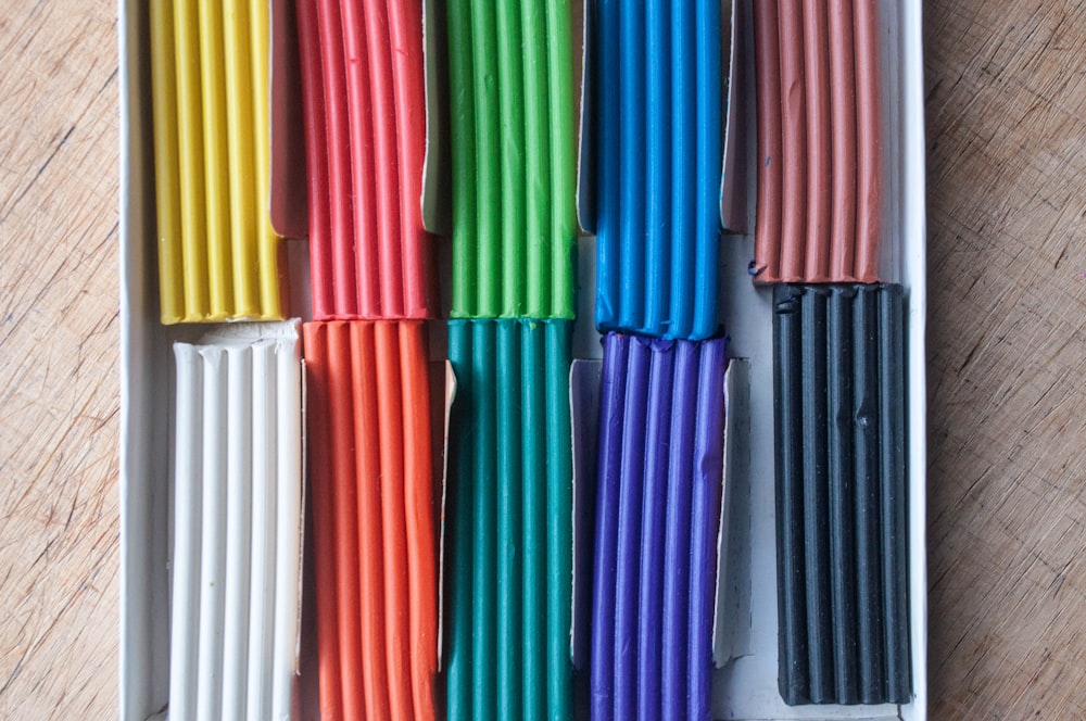 a box filled with lots of different colored sticks