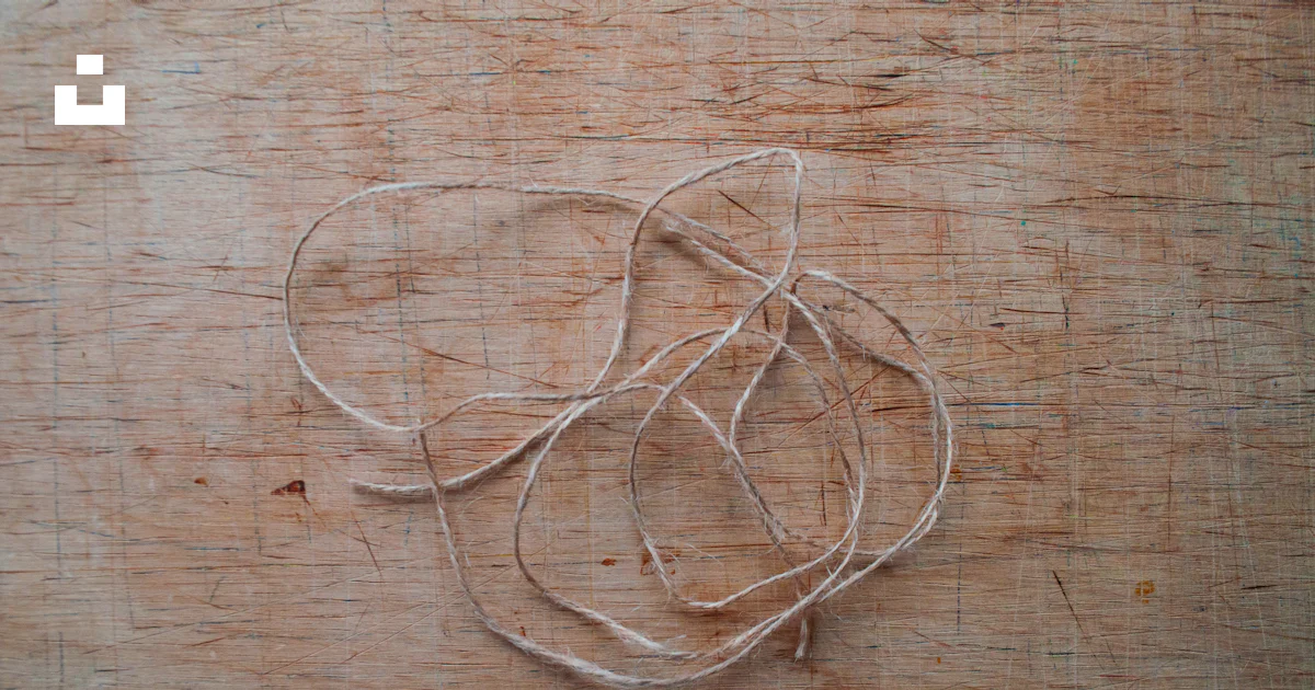 A close up of a string on a wooden surface photo – Free Table Image on ...