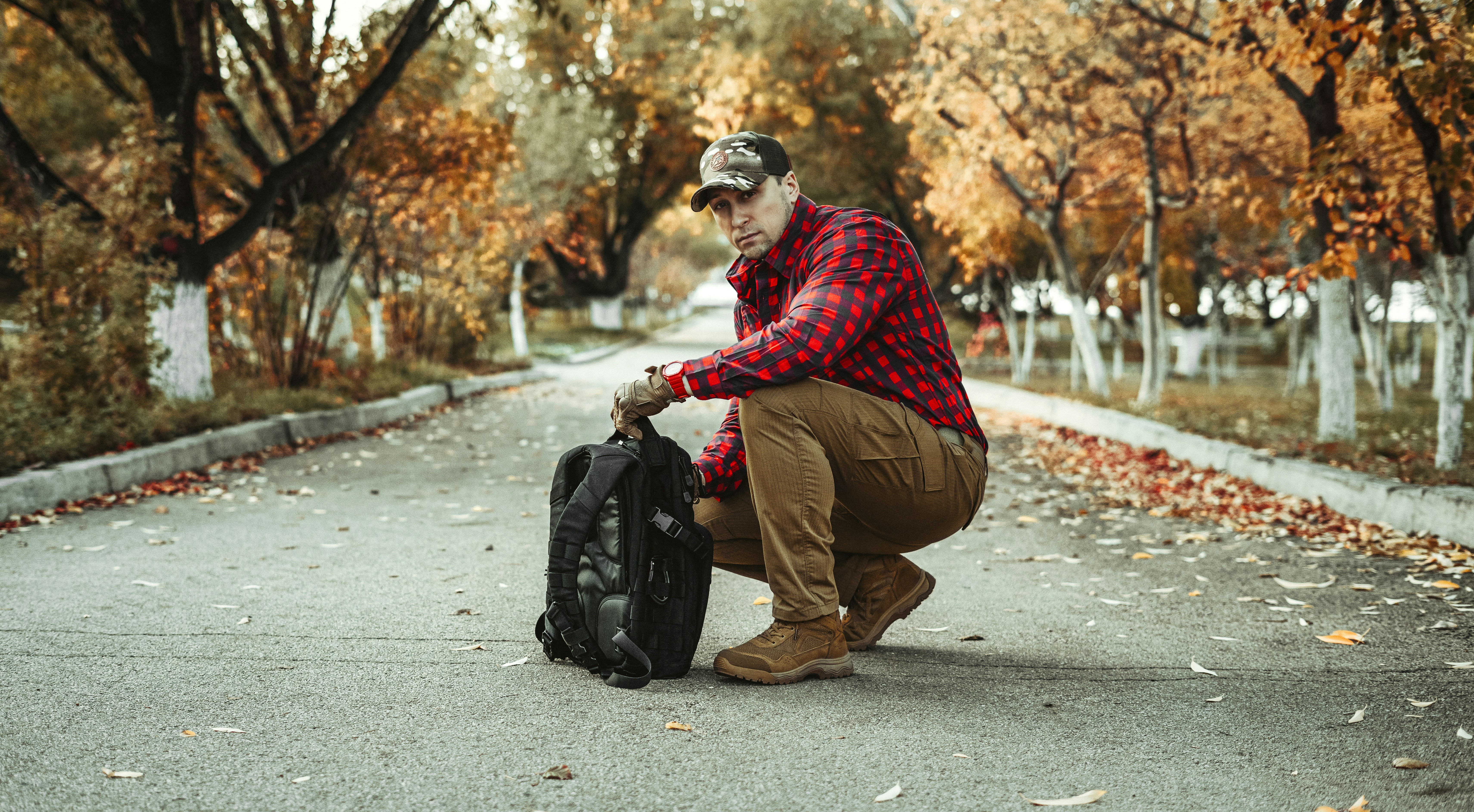 a man kneeling down with a suitcase in his hand