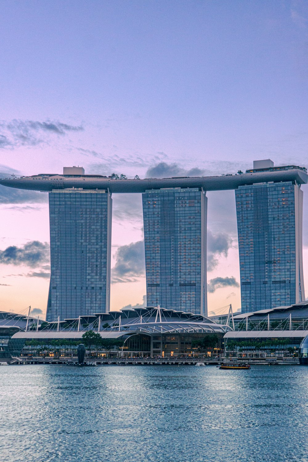 a large body of water with two tall buildings in the background