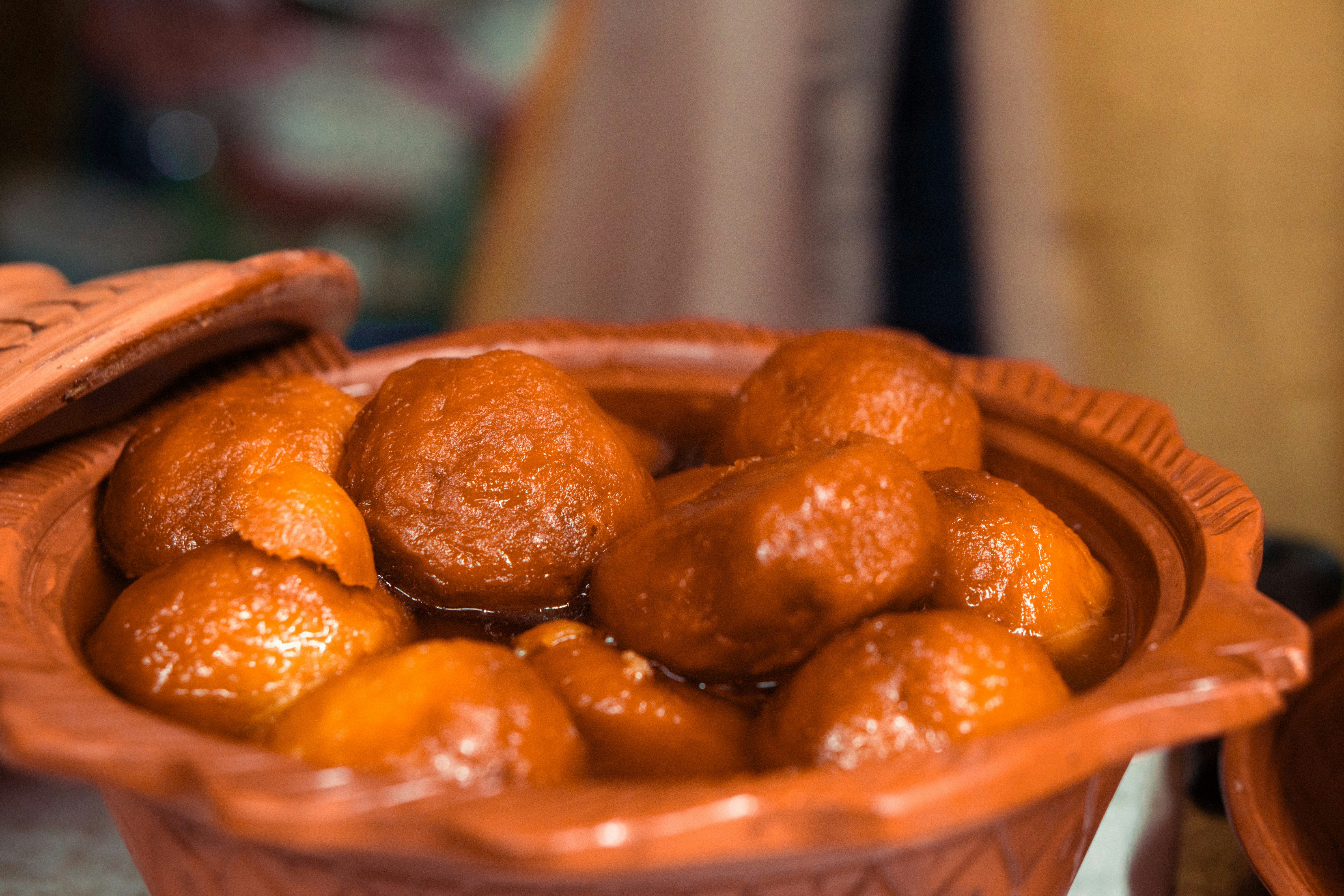 a bowl full of oranges sitting on a table