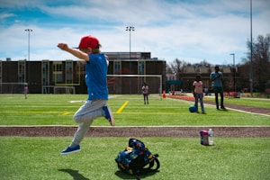 a young boy jumping in the air on a baseball field