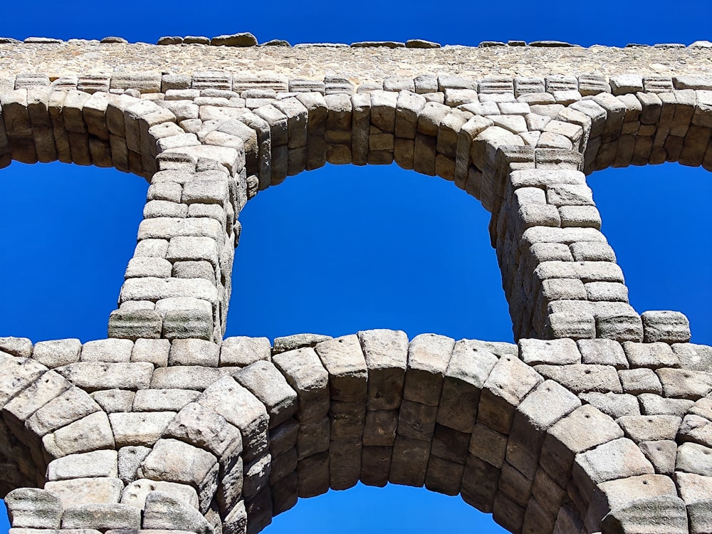 a close up of a brick structure with three windows