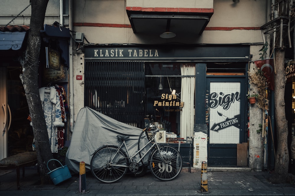 a couple of bikes parked in front of a building