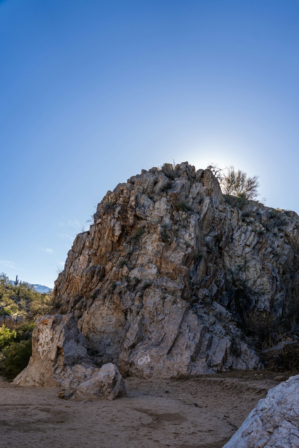 a large rock sitting on top of a dirt field