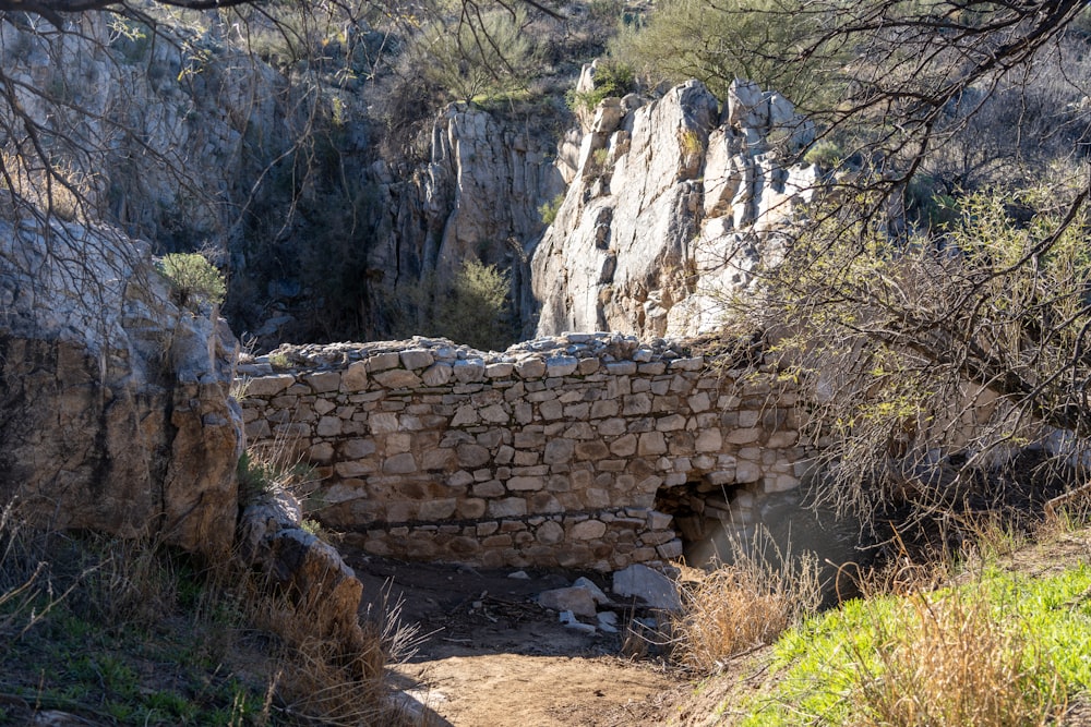 a stone bridge in the middle of a rocky area