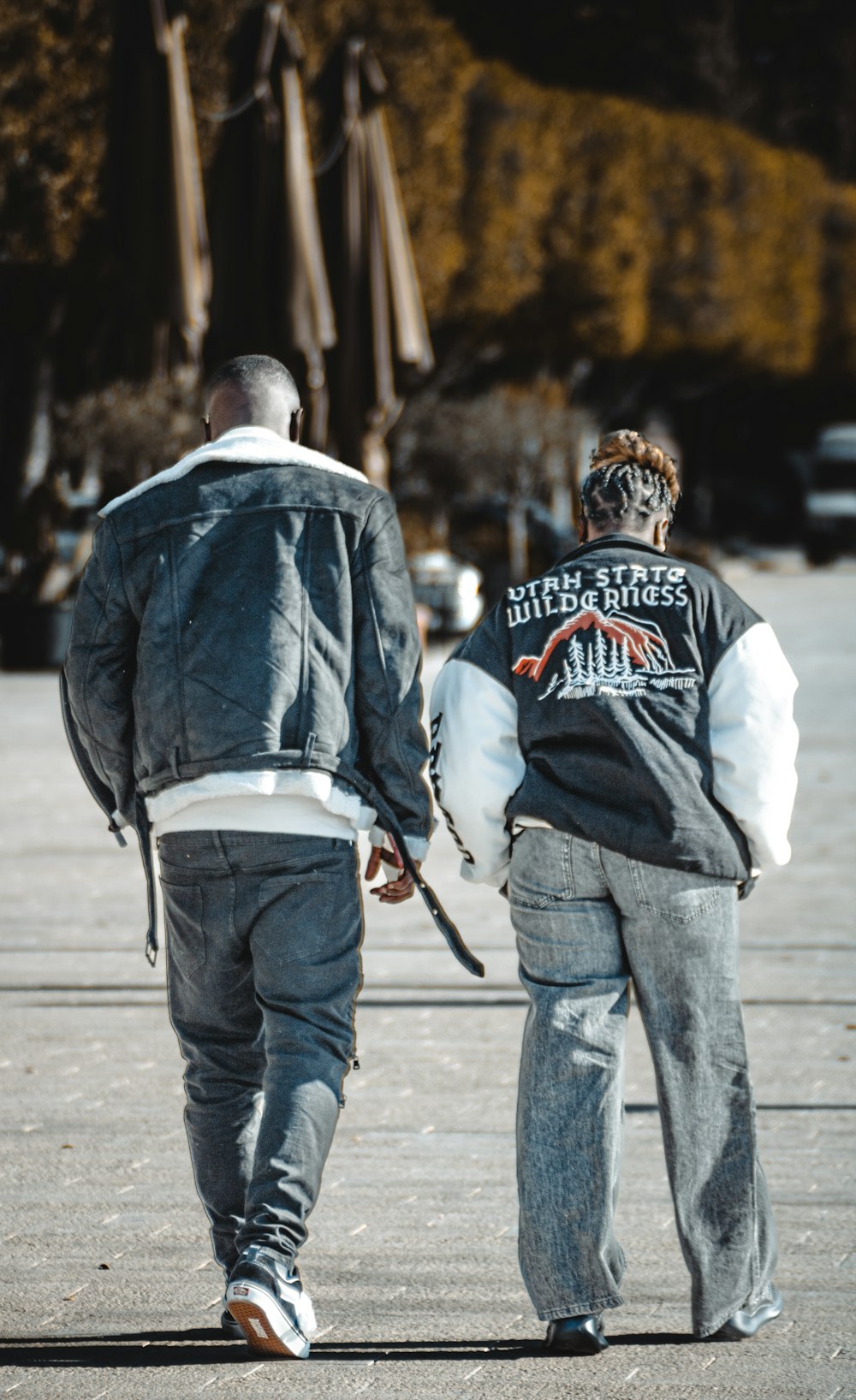 a couple of men walking down a street