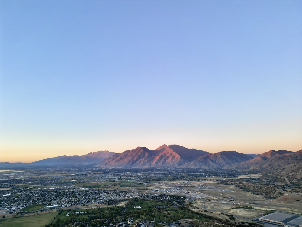 an aerial view of a city and mountains