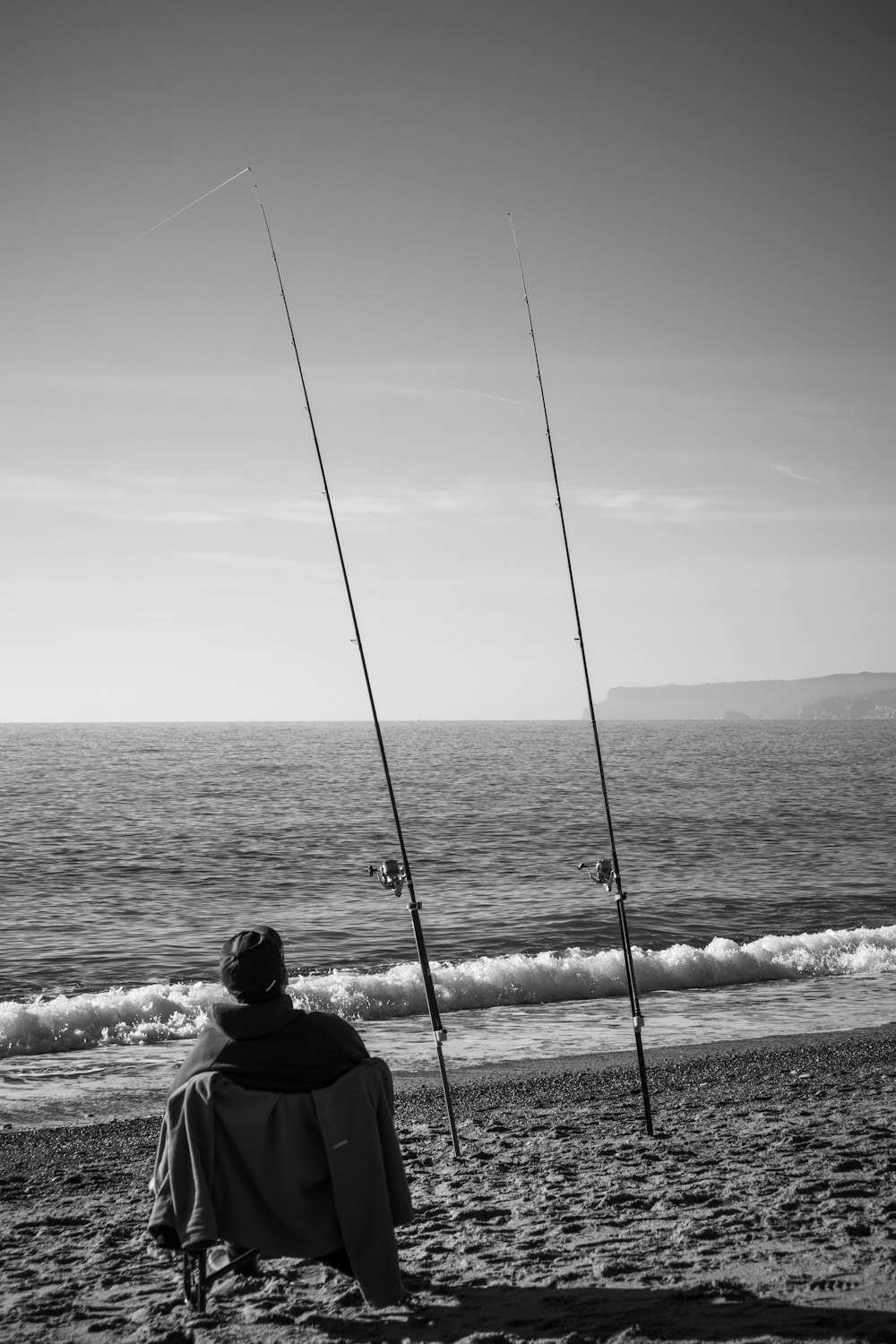 a man sitting in a chair on the beach