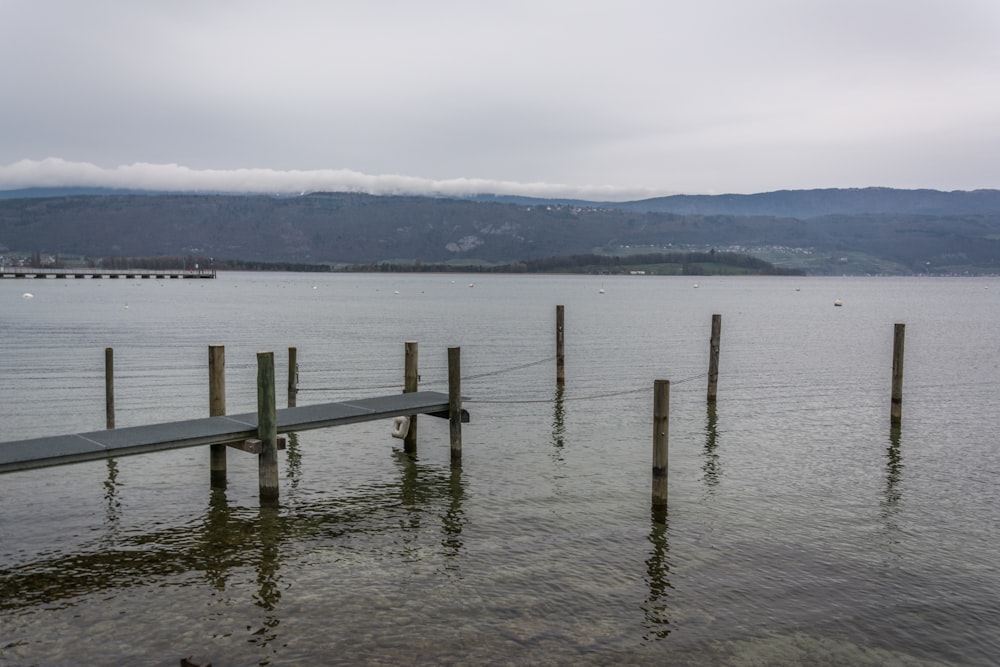 a wooden dock sitting in the middle of a lake