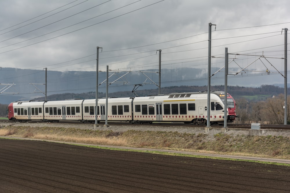 a train on a train track near a field