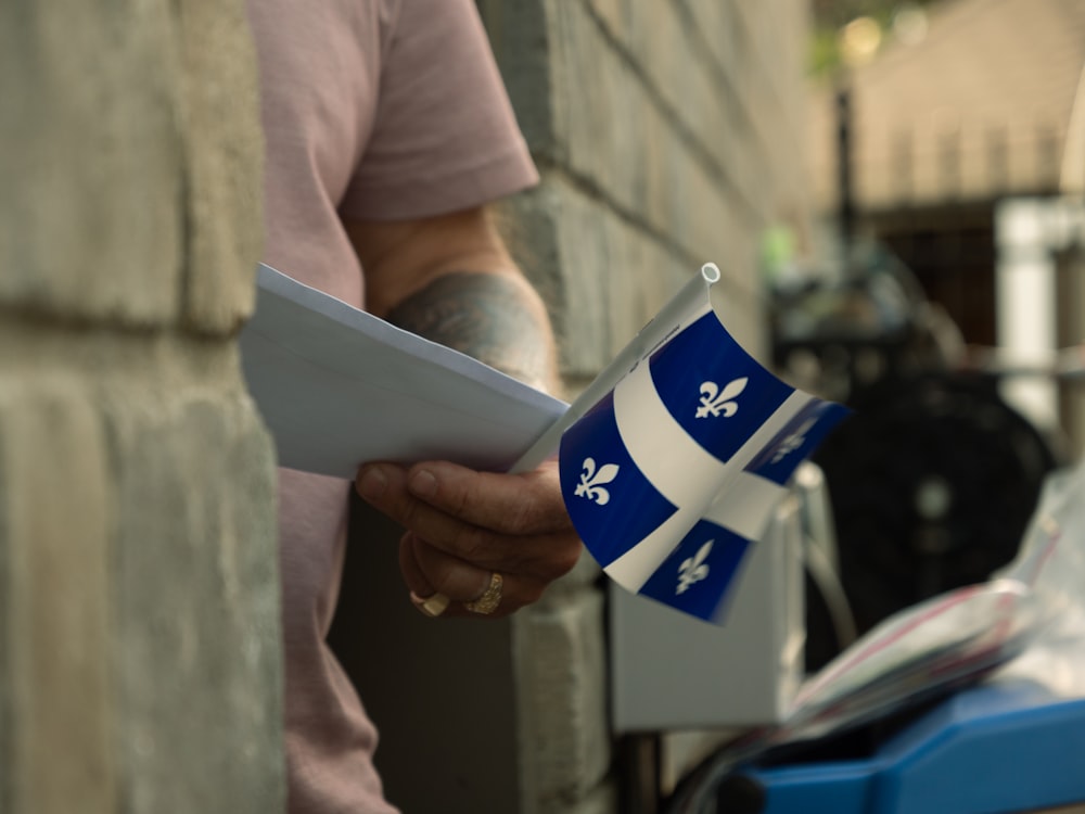 a close up of a person holding a piece of paper