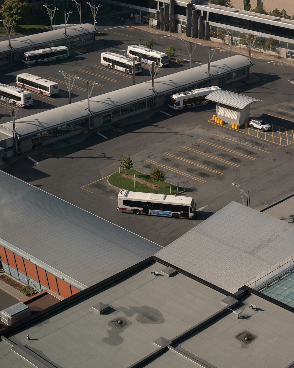 an aerial view of a parking lot with buses