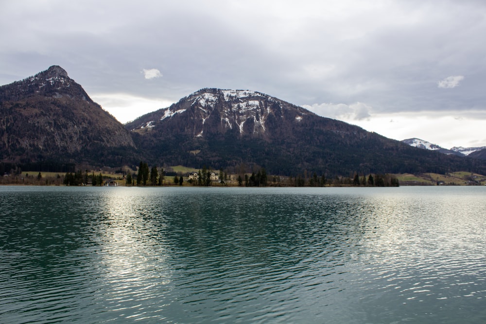 a large body of water with mountains in the background