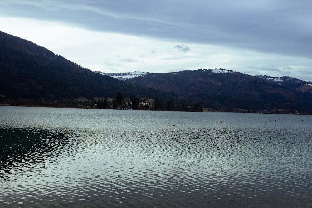 a large body of water with mountains in the background