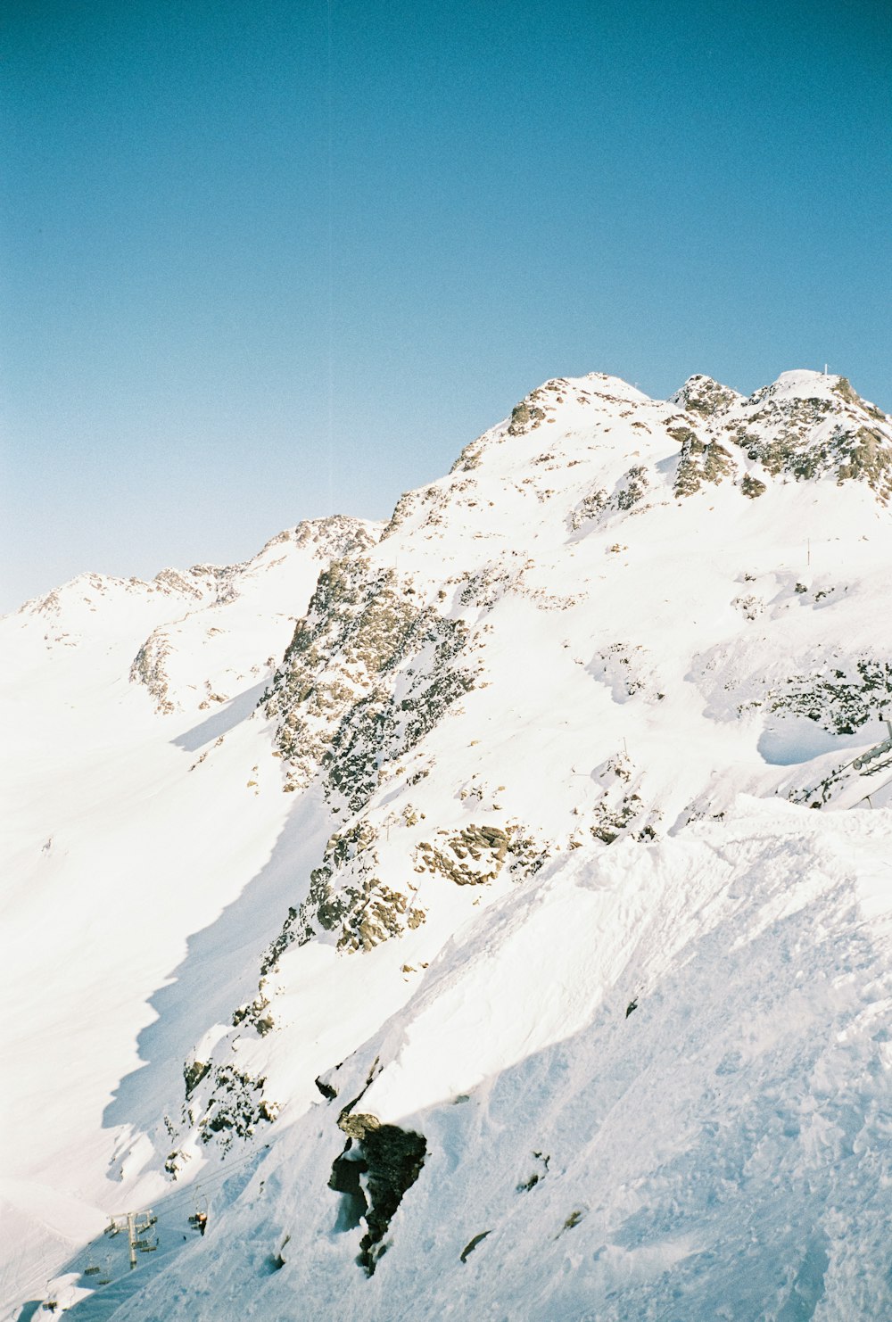 a man riding skis down the side of a snow covered mountain