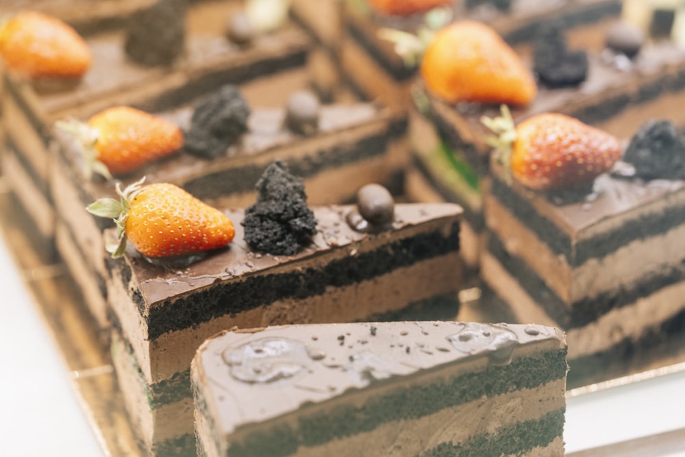 a close up of a slice of cake with fruit on top