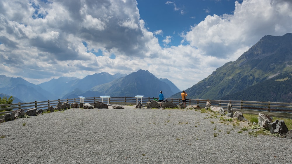 a couple of people standing on top of a mountain