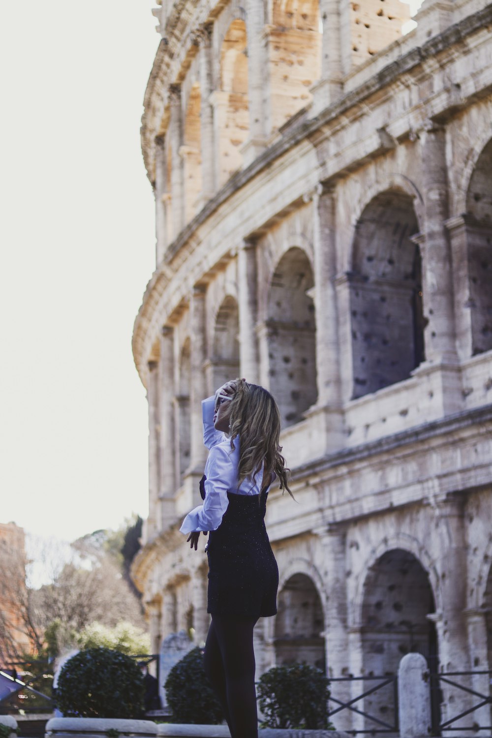 a woman standing in front of an old building