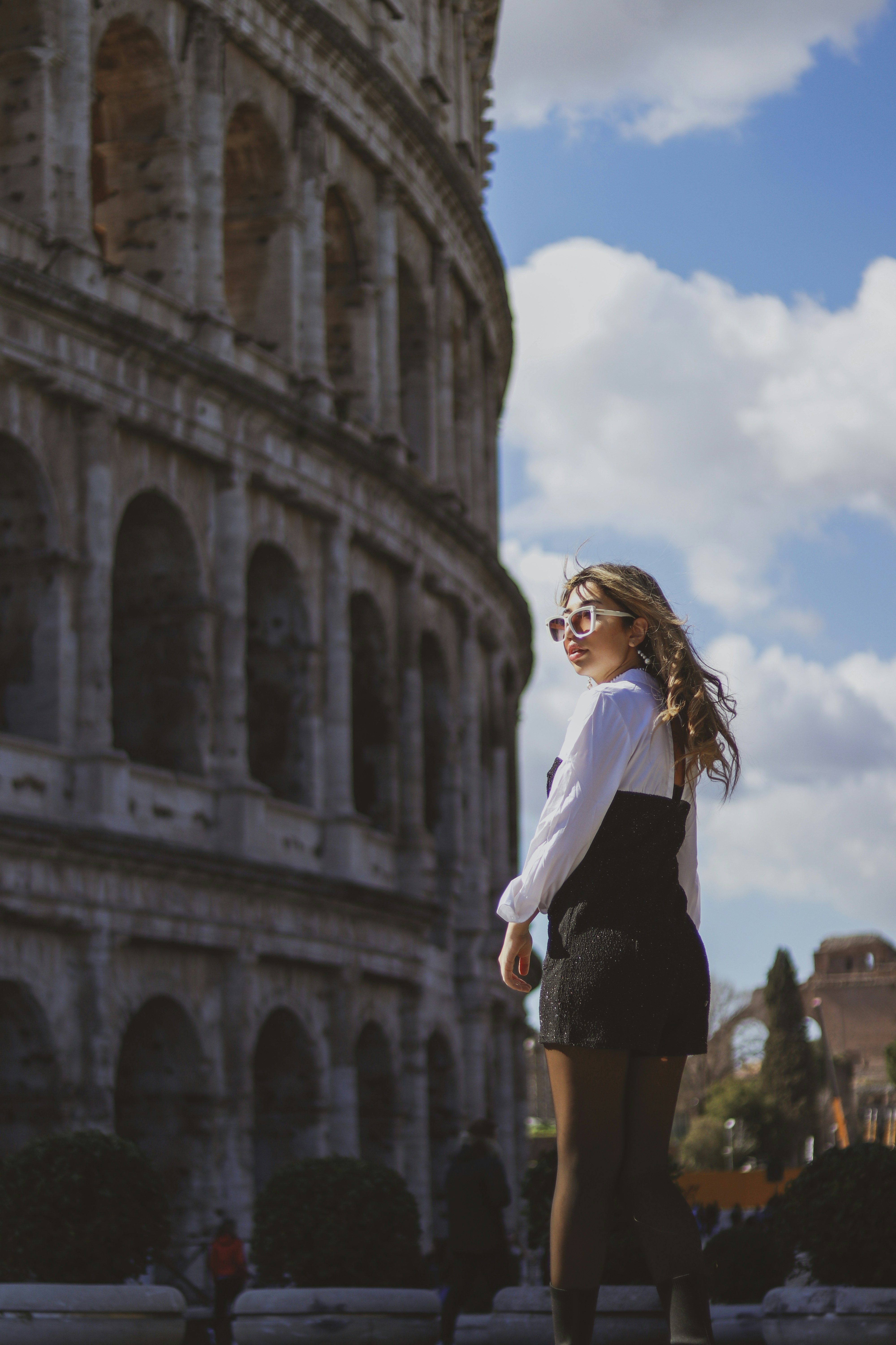 a woman standing in front of an old building