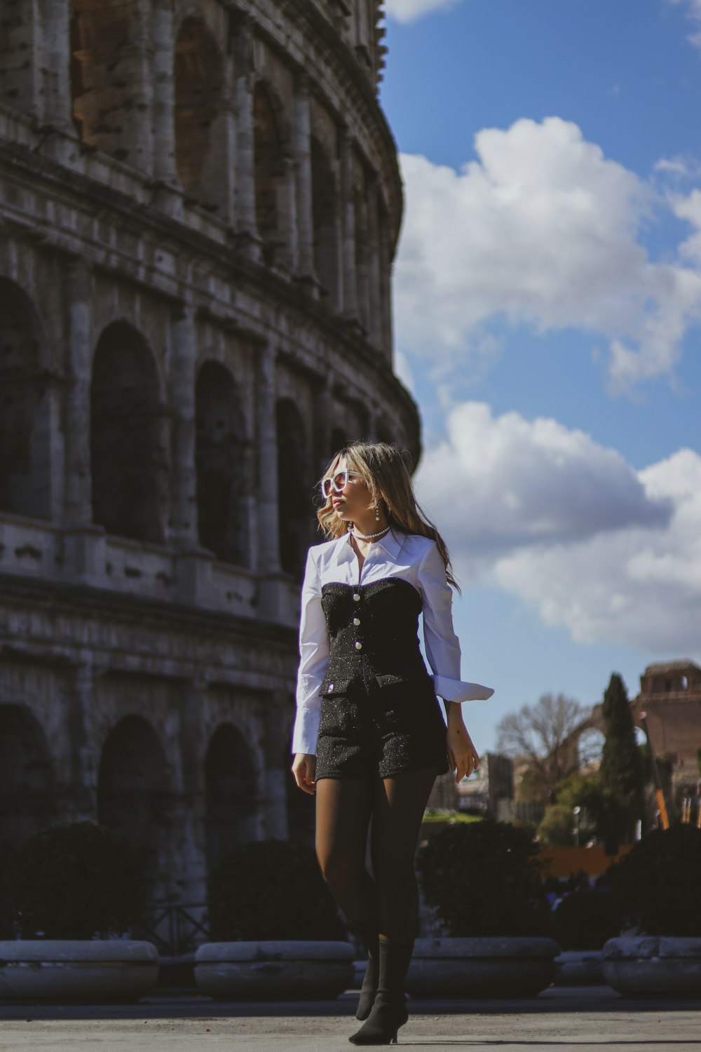 a woman in a white shirt and black skirt