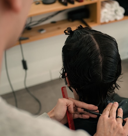 a man getting his hair cut in a salon