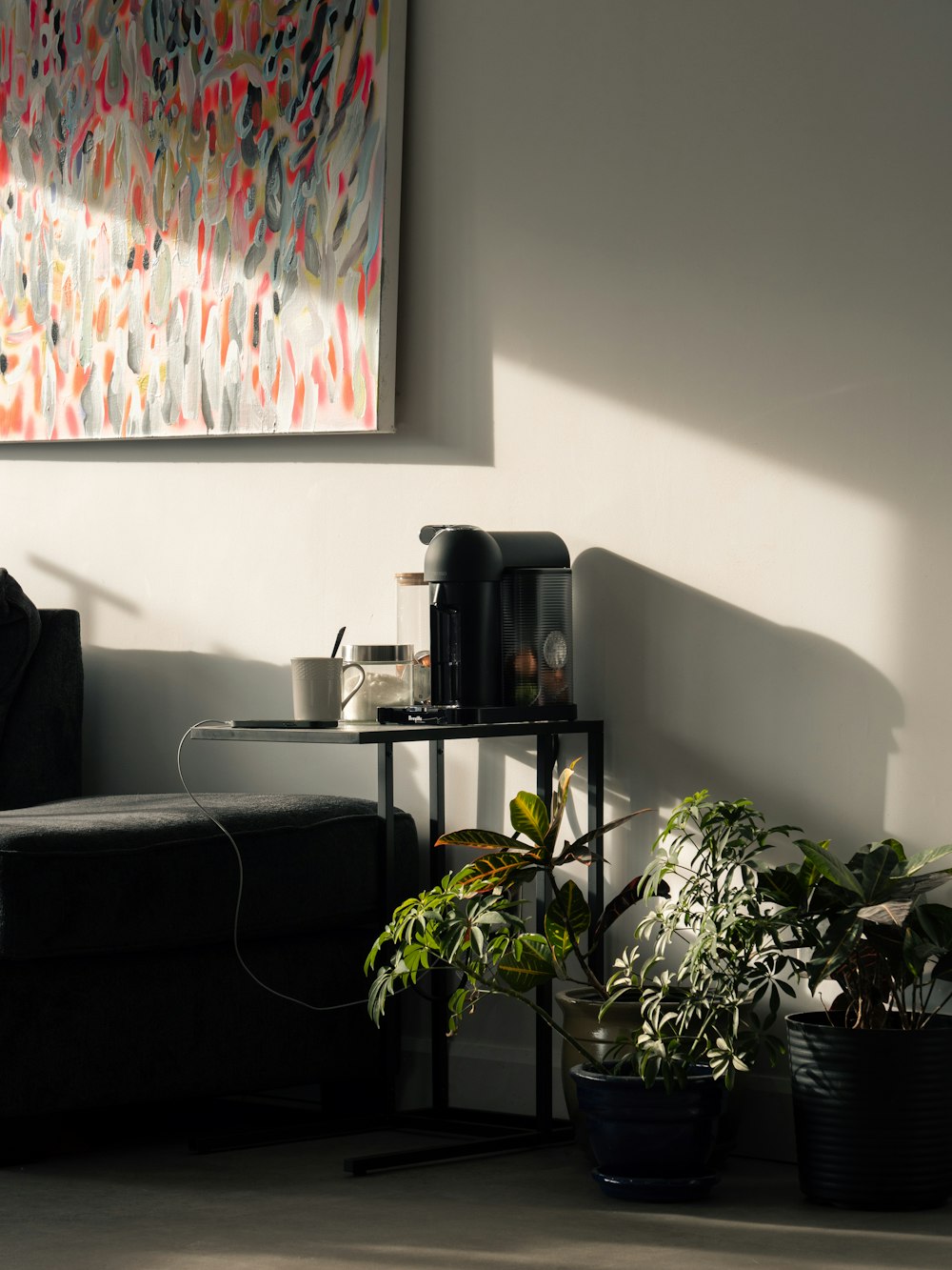 a living room filled with furniture and a painting on the wall