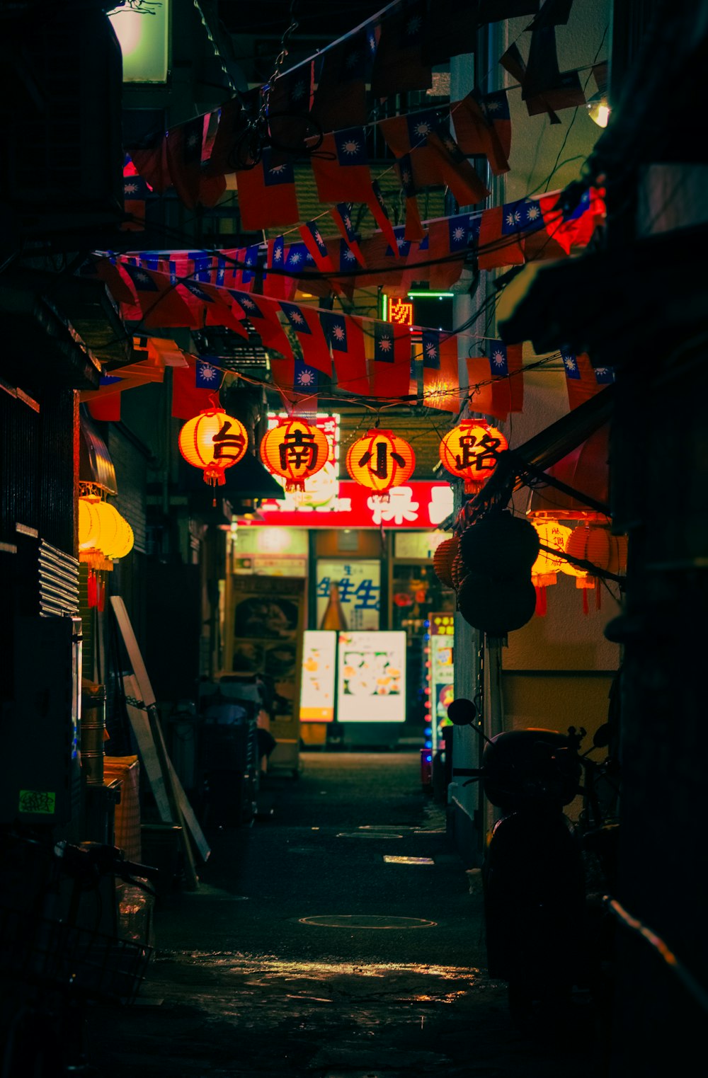 a narrow alley way with chinese lanterns hanging from the ceiling