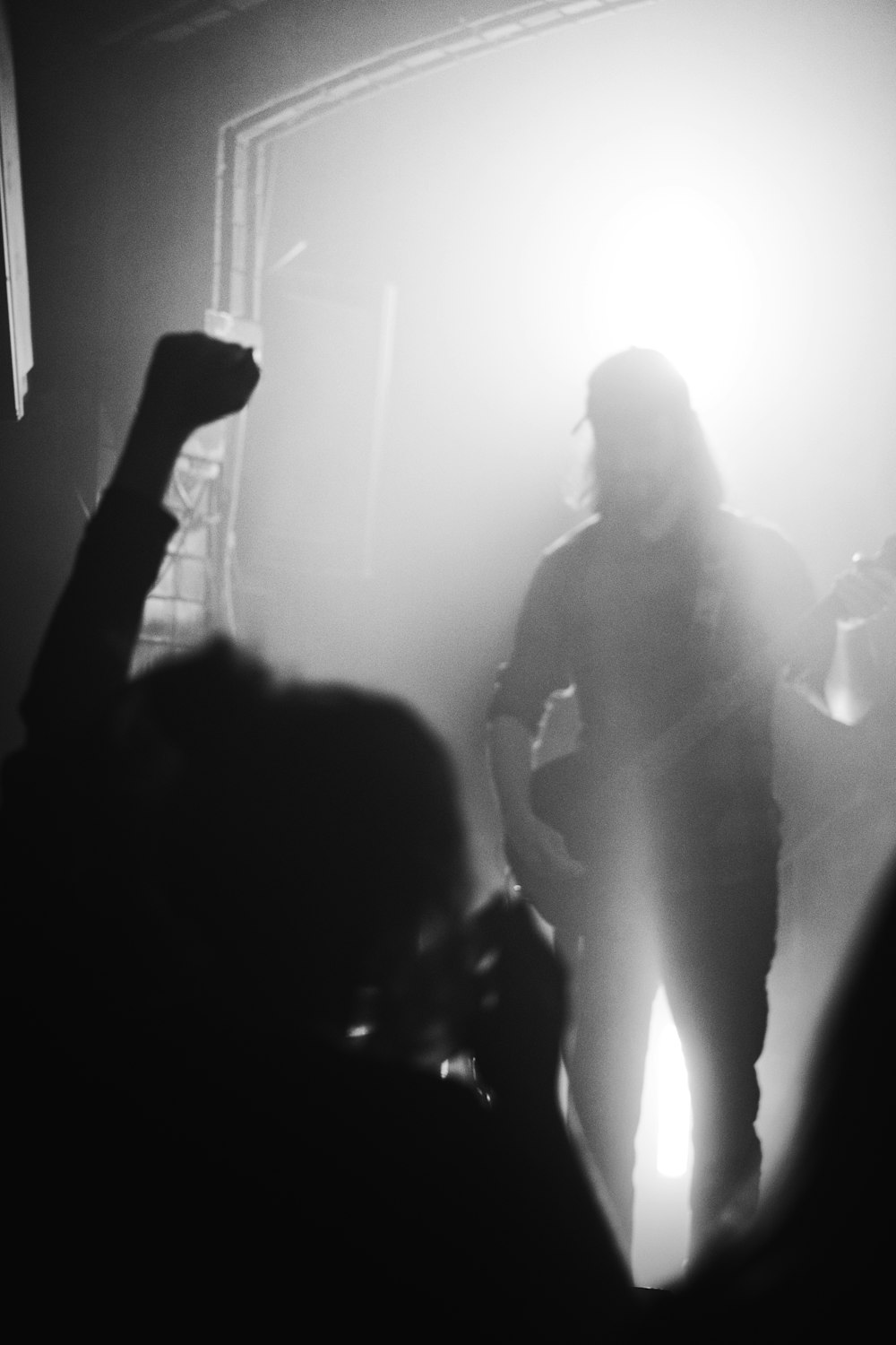 a black and white photo of a person playing a guitar