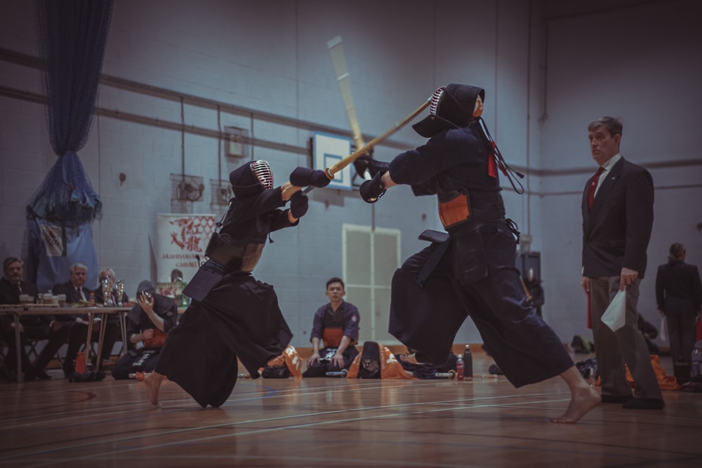 a group of people on a court playing a game of karate