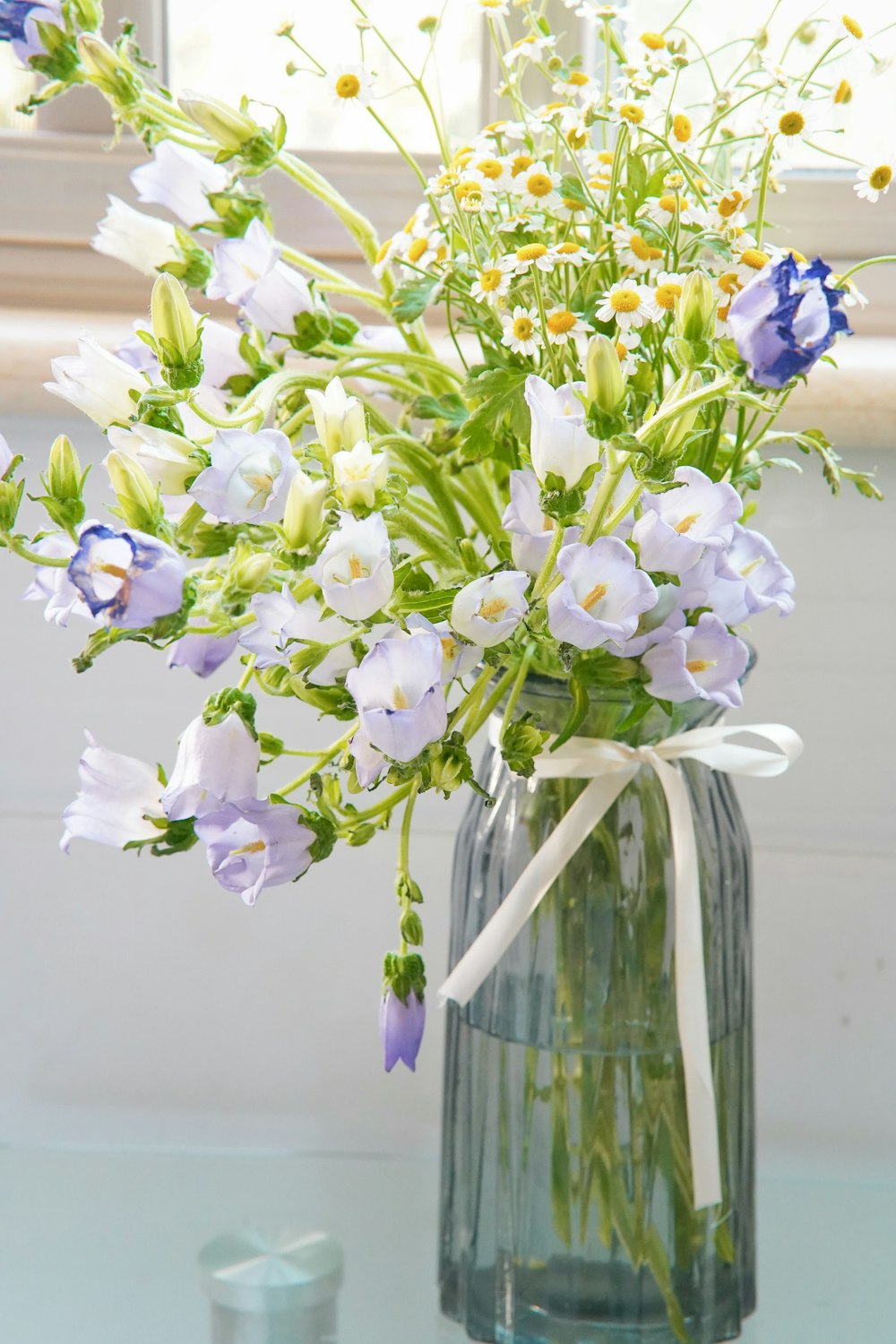 a vase filled with purple and white flowers