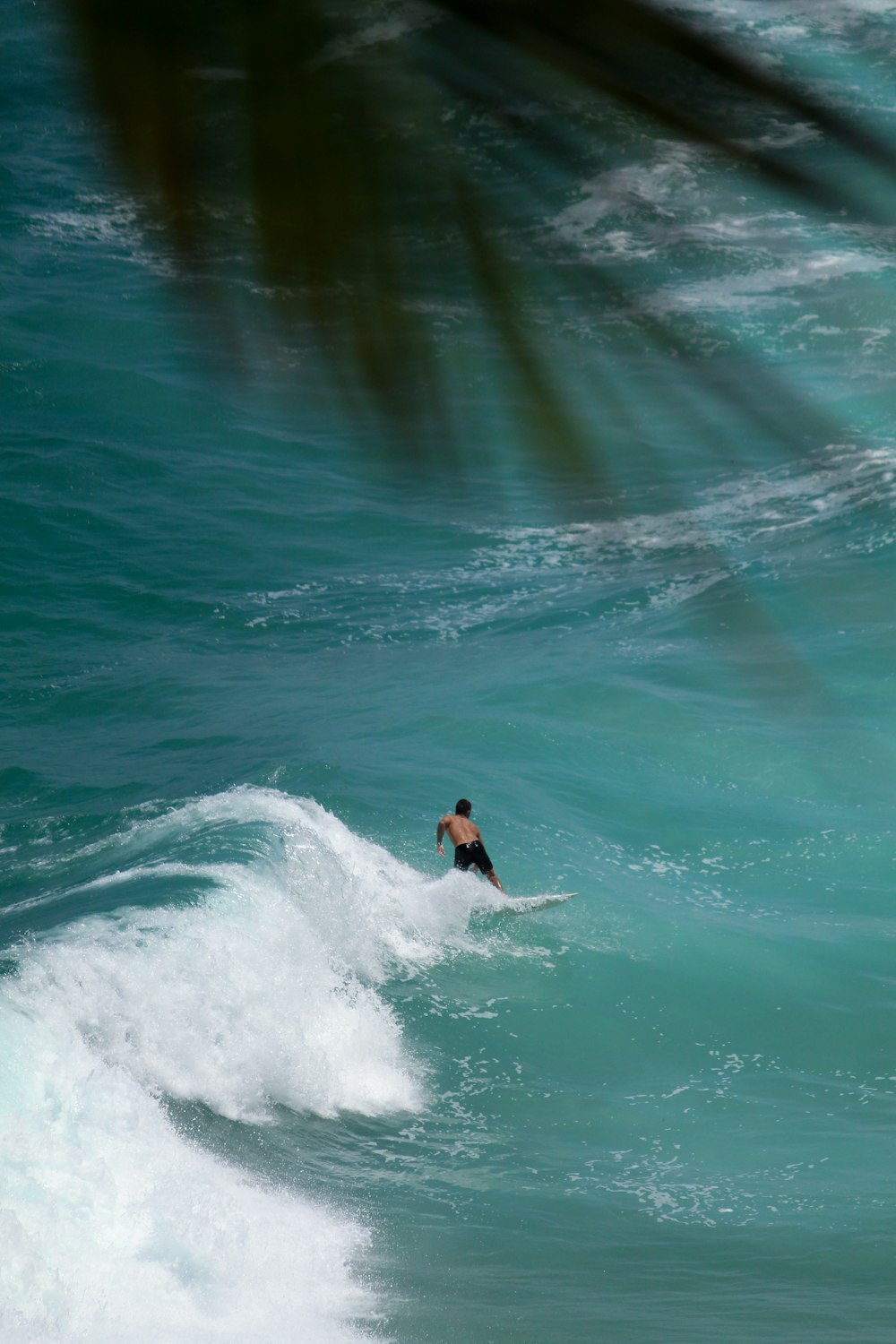 a man riding a wave on top of a surfboard