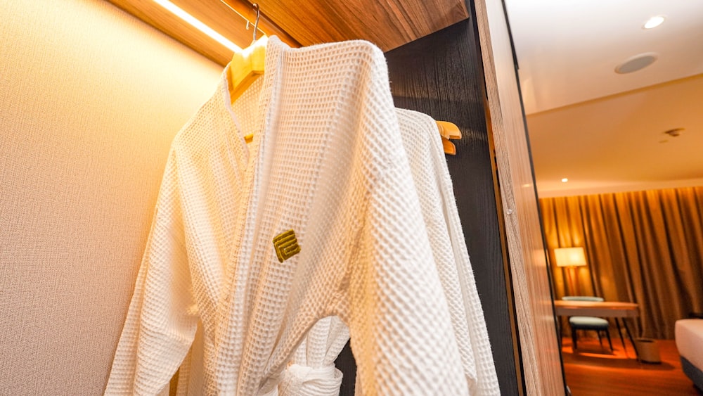 a robe hanging on a wall in a hotel room