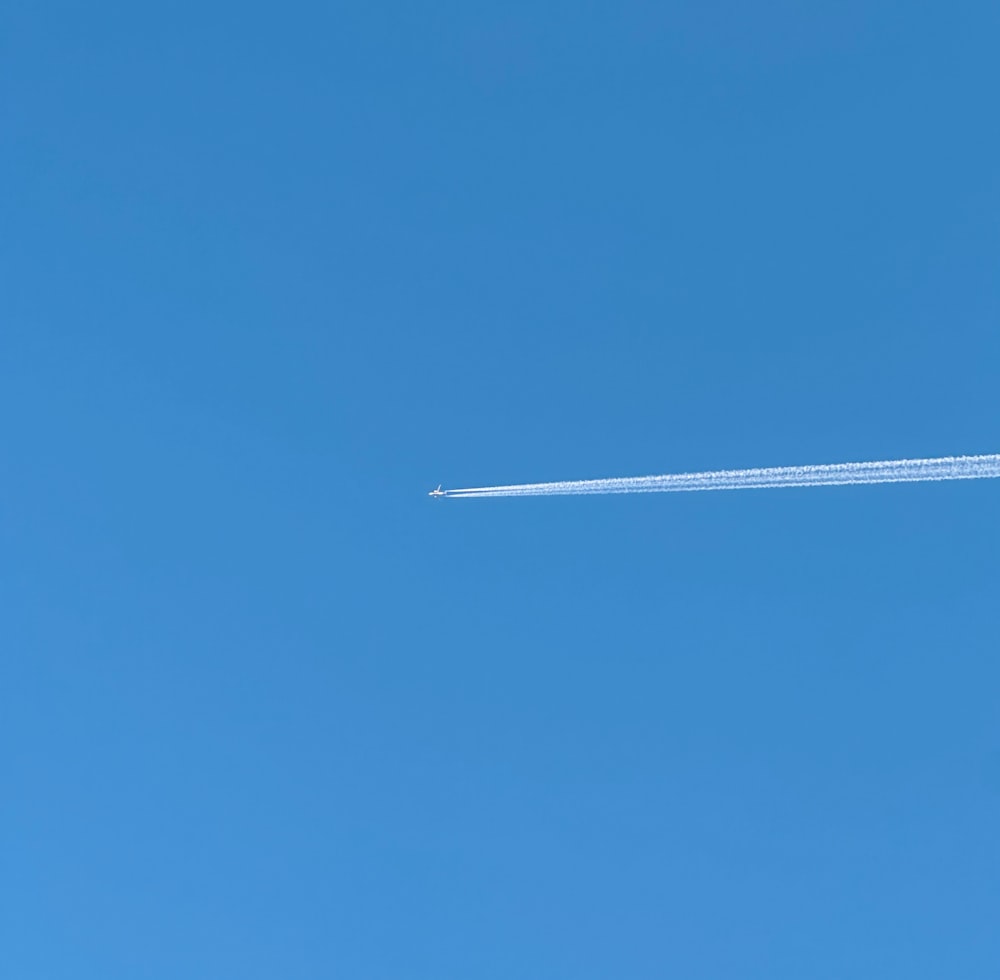 an airplane is flying in the clear blue sky