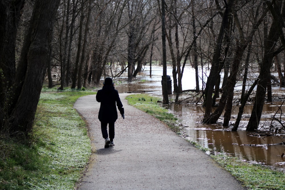 a person walking down a path in the woods