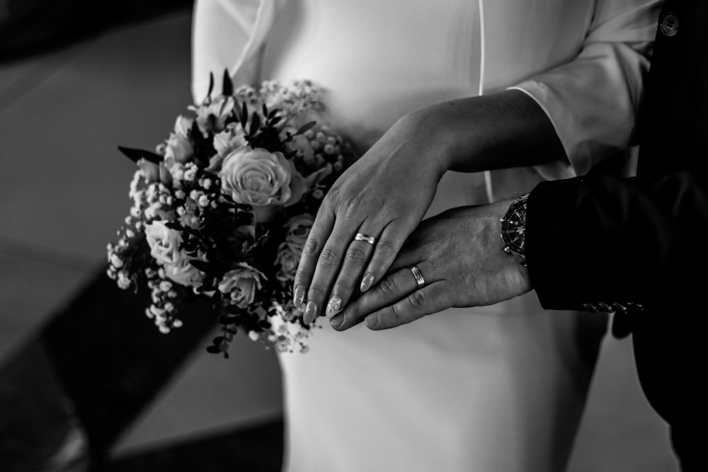 a close up of a person holding a bouquet of flowers