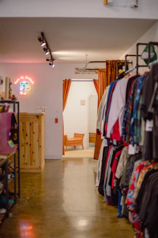 a room filled with lots of clothes and a chair